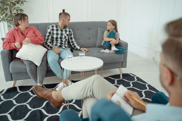 Tough family therapy session for parents and their young daughter.